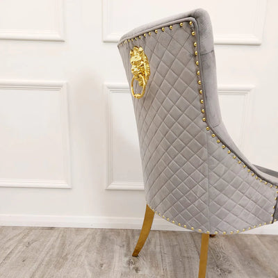 Louis Gold Marble Dining Table With Gold Quilted Lion Knocker Velvet Chairs